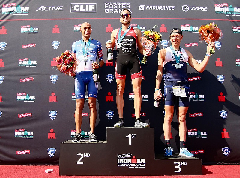 Matt Russell, Cody Beals and Kirill Kotsegarov celebrate their second-place, first-place and third-place finishes respectively in Ironman Chattanooga Sunday, September 30, 2018 in Chattanooga, Tennessee. Beals has competed in two Ironman events and has placed first in both.