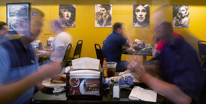 Staff photo by C.B. Schmelter/ Bruce Weiss's sketches hang on the wall at River Street Deli on Friday, Aug. 16, 2019 in Chattanooga, Tenn.