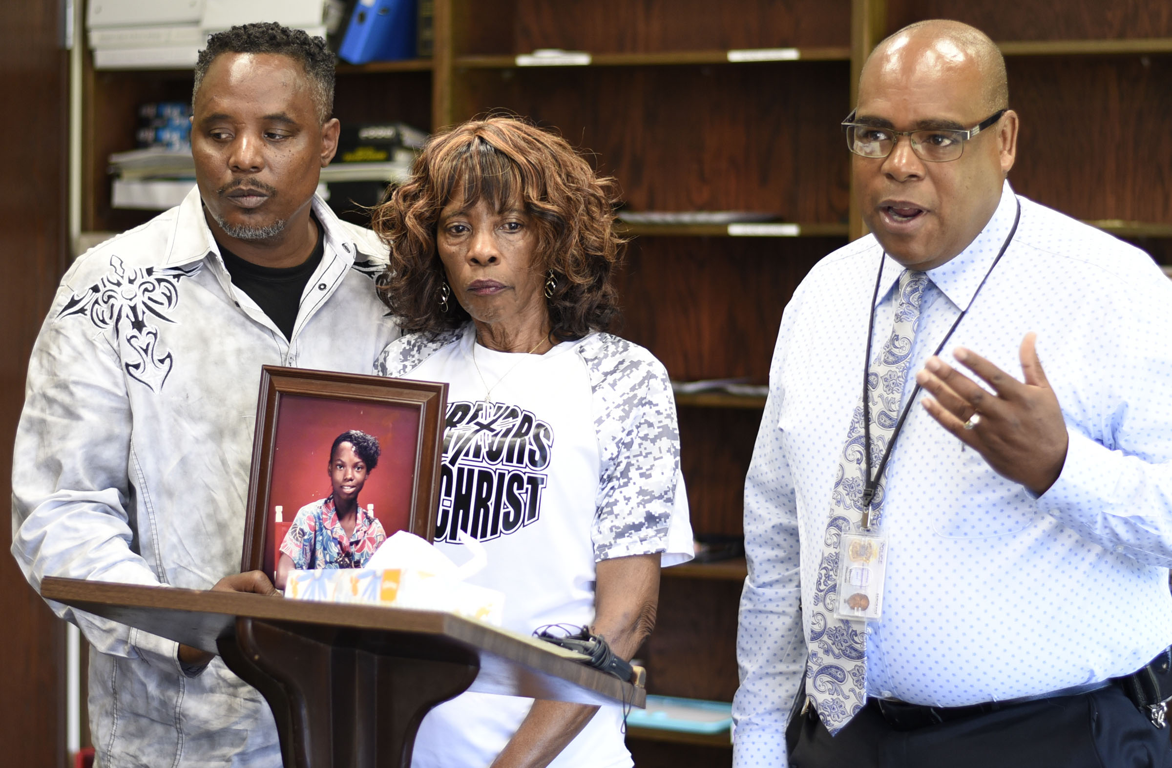 Staff Photo by Robin Rudd/ Chattanooga Police Sergeant Vincent Holoman, of the missing persons unit, talks to the media about the case of Tonetta Carlisle. Standing behind a photo of Tonetta are her brother Darrell Stewart, and mother Nonie Sturdivant. The Hamilton County District Attorney office announced the reopening of a cold case. Tonetta Carlisle was 15-years old when she disappeared on March 16, 1989. Jeffery Jones was listed as a person-of-interest during the press conference held on August 29, 2019.