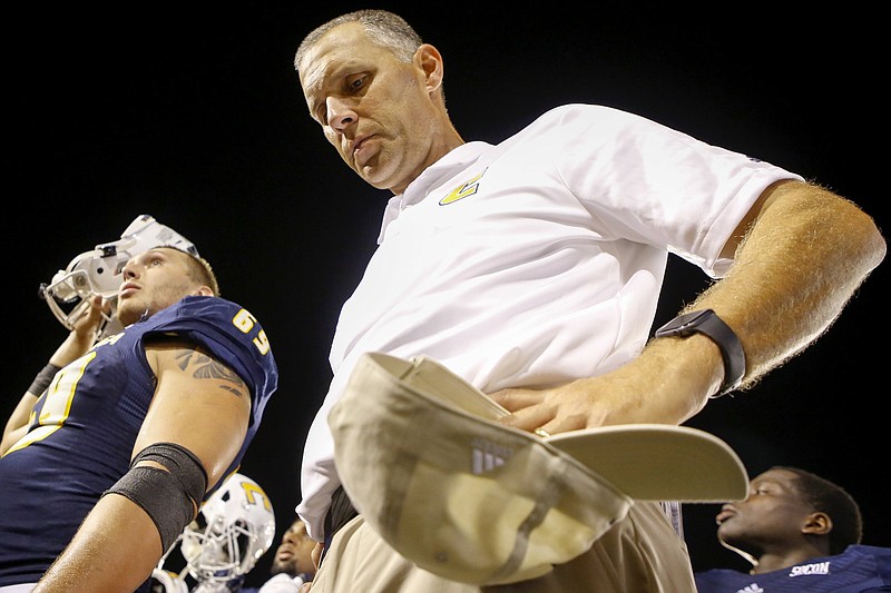 Staff photo by C.B. Schmelter / UTC alumnus and new head football coach Rusty Wright is emotional as his team sings the alma mater after Thursday's 24-10 season-opening victory over Eastern Illinois at Finley Stadium.