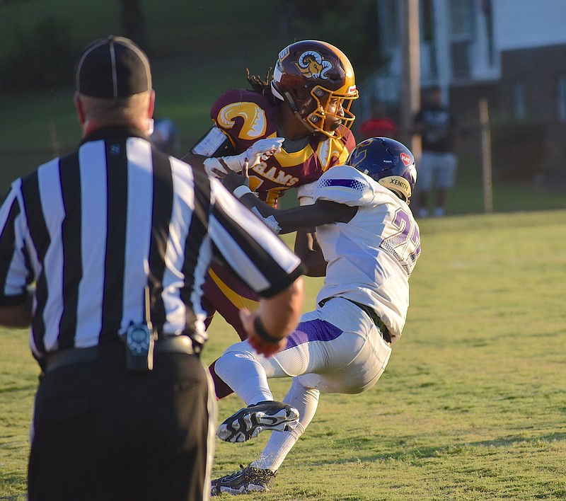 Staff photo by Patrick MacCoon / Tyner's Jeremiah Batiste stiff-arms a defender to the ground during the Rams' home win against Central on Friday night.