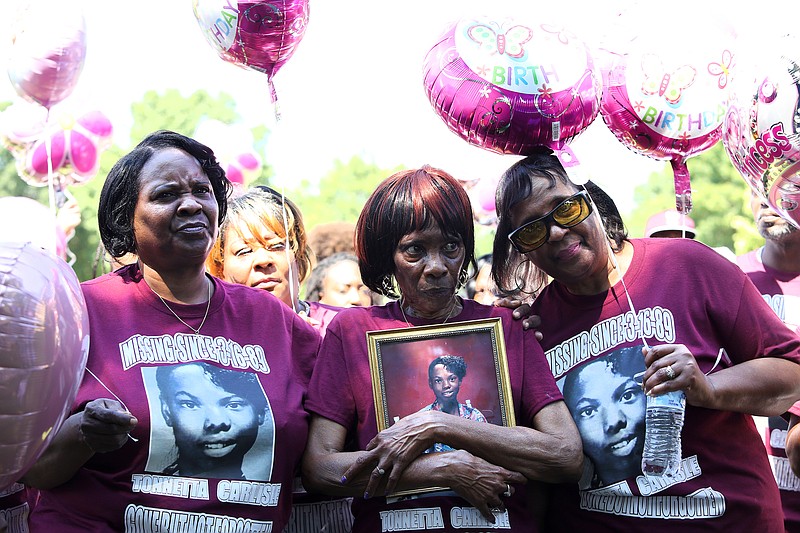 Staff photo by Erin O. Smith / Nonie Sturdivant, center, is surrounded by her sisters Gladys White and Frances Hollingsworth during a balloon release held for Tonetta Carlisle Saturday, August 31, 2019 in Coolidge Park in Chattanooga, Tennessee. Sturdivant is the mother of Carlisle, who disappeared when she was 15 years old in 1989. The family was both celebrating Carlisle's birthday and trying to raise awareness in the hopes that someone would come forward with information.