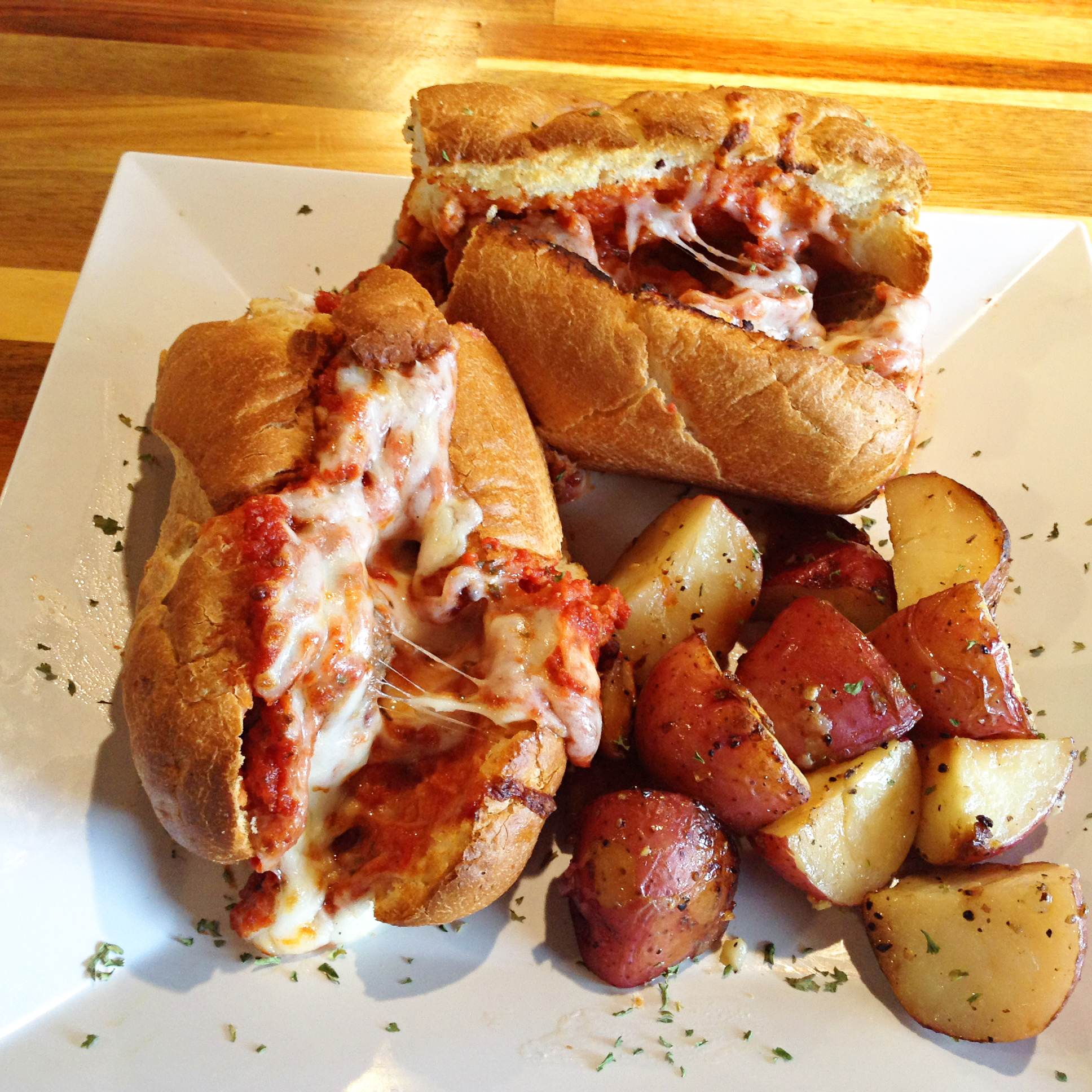 Staff Photo by Chris Zelk / The Stevarinos meatball hoagie with roasted red potatoes.