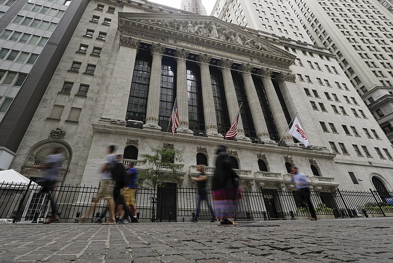 FILE - In this Aug. 23, 2019, file photo pedestrians pass the New York Stock Exchange in New York. Global stock markets were mostly lower Tuesday, Sept. 3, amid revived jitters over U.S.-Chinese trade tension, while wrangling by British lawmakers over whether to try to postpone Brexit saw the pound fall further. (AP Photo/Frank Franklin II, File)