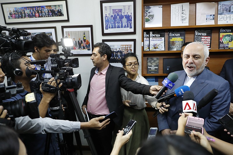 The Associated Press/Iranian Foreign Minister Mohammad Javad Zarif, right, speaks to reporters last week, reiterating his country would not meet with the U.S. unless it ended economic sanctions against the country.