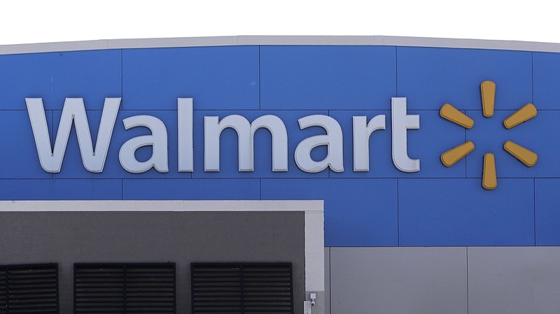 A Walmart logo is attached to the outside of a Walmart store, Tuesday, Sept. 3, 2019, in Walpole, Mass. Walmart is going back to its folksy hunting heritage and getting rid of anything that's not related to a hunting rifle after two mass shootings in its stores in one week left 24 people dead in August of 2019. (AP Photo/Steven Senne)


