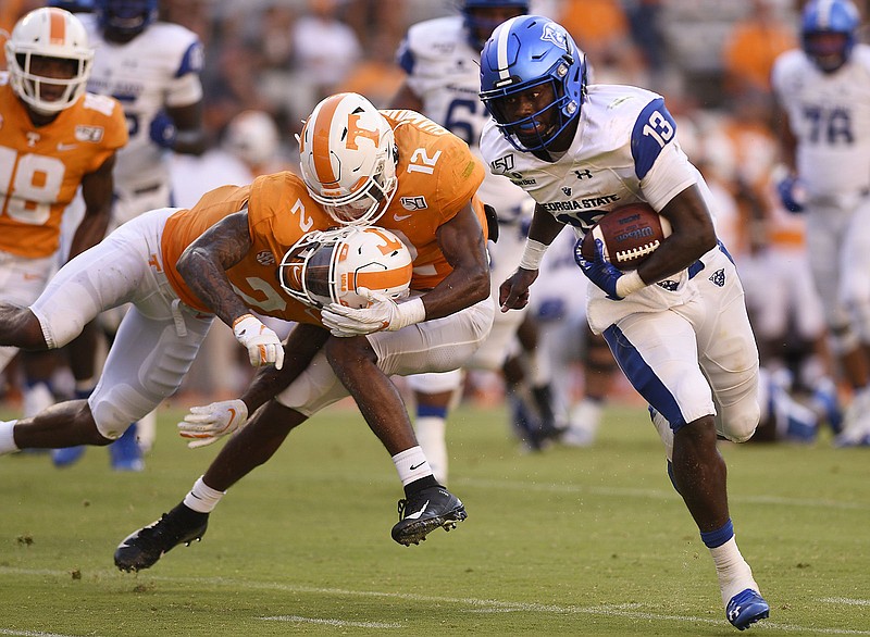 Staff Photo by Robin Rudd / Georgia State quarterback Dan Ellington carries the ball to the end zone for a touchdown as Tennessee's Alontae Taylor (2) and Shawn Shamburger (12) collide in the background during last Saturday's game at Neyland Stadium. Ellington was afforded the chance to make a number of plays when the Vols had trouble lining up properly on defense.