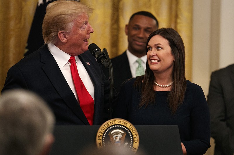 President Donald Trump welcomes White House press secretary Sarah Sanders to the White House East Room stage in June and thanks her for her service to the administration. / AP file photo/Jacquelyn Martin