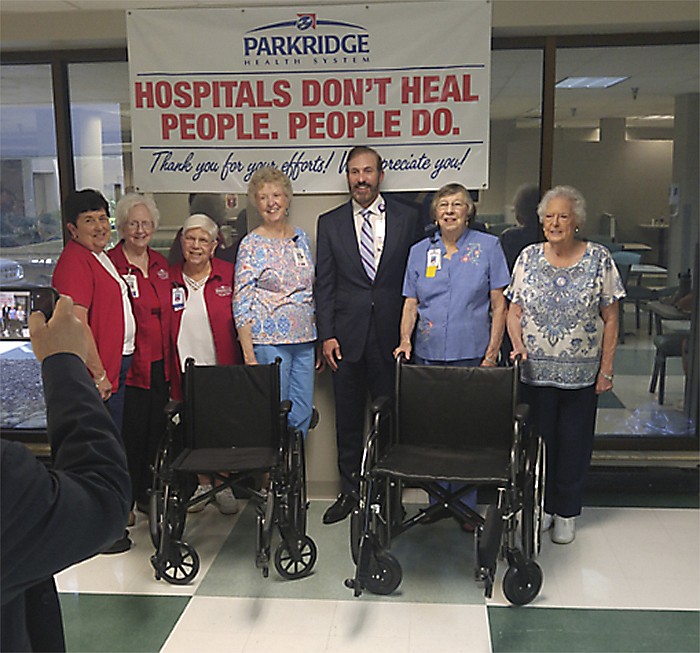 Donating the wheelchairs to the hospital, from left, are: Sherri Goins, Estelle Dill, Jill Williams, Shirley Thomas, vice president of Scenic City Friends, Tom Ozburn, CEO of Parkridge Health System, Judy Grammer, president of SCF and Dana Strunk, board member SCF.