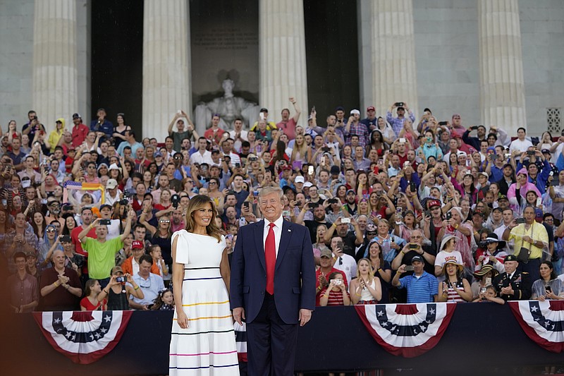 President Donald Trump and first lady Melania Trump at the "Salute to America" celebration on Independence Day, at the Lincoln Memorial in Washington, July 4, 2019. The first lady's slouching-off-one-shoulder mid-calf Carolina Herrera dress, complete with rainbow stripes, caused some observers to wonder if she was using the occasion to celebrating gay pride. (Erin Schaff/The New York Times)