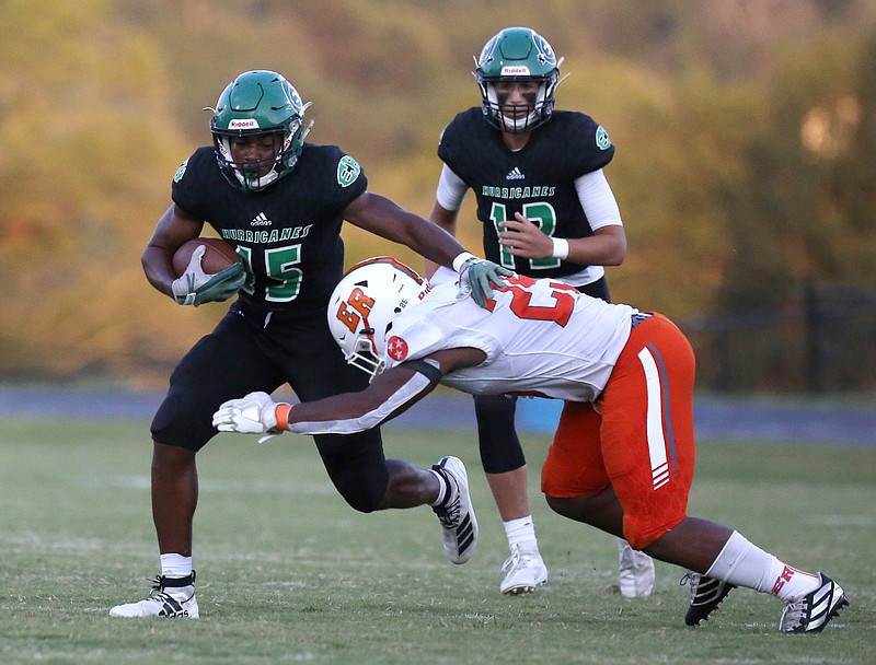 Staff photo by Erin O. Smith / East Hamilton's Adam Caudle is hit by East Ridge's Jalen Boykin after taking the handoff from quarterback Haynes Eller, rear, during Friday night's game at East Hamilton.