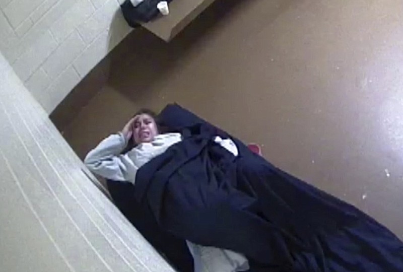 This July 31, 2018 photo from surveillance video released to Killmer, Lane & Newman, LLP law firm by the Denver County Jail shows Diana Sanchez, an inmate about to give birth alone in her Denver jail cell. Sanchez is suing the city after she says her pleas for help were ignored during about five hours of labor. Clips of silent surveillance video released by her lawyer show Diana Sanchez eventually lying down on a narrow bed, crying out in pain, before she pulls off her pants and delivers a baby boy. (Killmer, Lane & Newman/Denver County Jail via AP)


