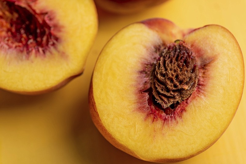 This August 2018 photo shows peaches in New York. In the last warm weeks of summer, it's hard to imagine that all of today's tomatoes and corn and peaches will be but memories in just a couple of months. With a bit of forethought, and a bit of time, we can safeguard some of this magnificent produce and draw upon it all winter long. When you preserve food, you are using techniques to stop its natural decomposition, killing or preventing the growth of microbes. (Cheyenne Cohen/Katie Workman via AP)


