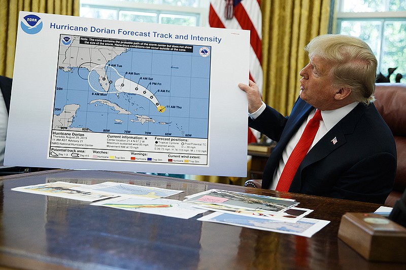 President Donald Trump holds a doctored chart as he talks with reporters in the Oval Office on Wednesday. / AP Photo/Evan Vucci