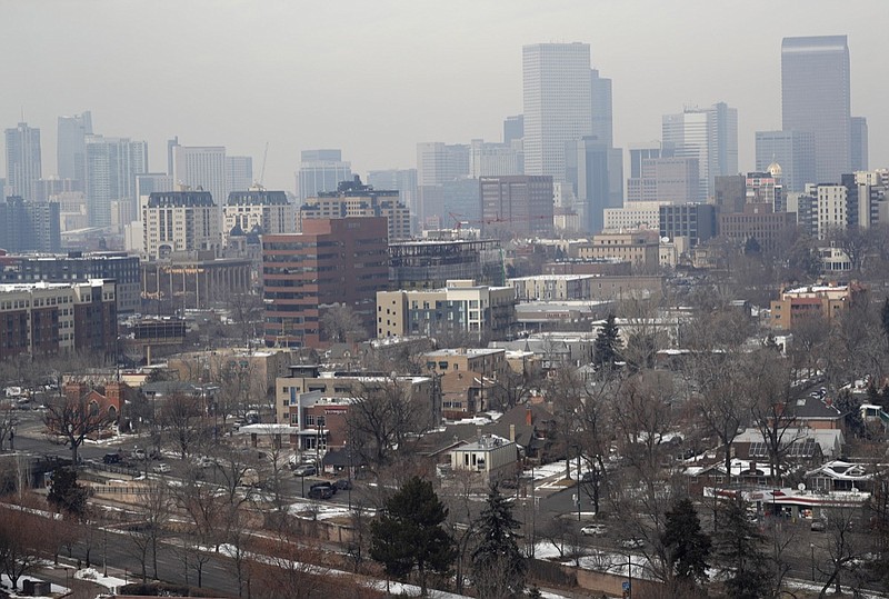 FILE - In this March 6, 2019, file photo, as traffic rolls along Speer Boulevard in the foreground, the skyline is shrouded as pollution fills the air in Denver. Colorado has taken the unusual step of inviting the U.S. Environmental Protection Agency to downgrade the air quality rating of the state's biggest population center, and not everyone thinks that is a good idea. (AP Photo/David Zalubowski, File)


