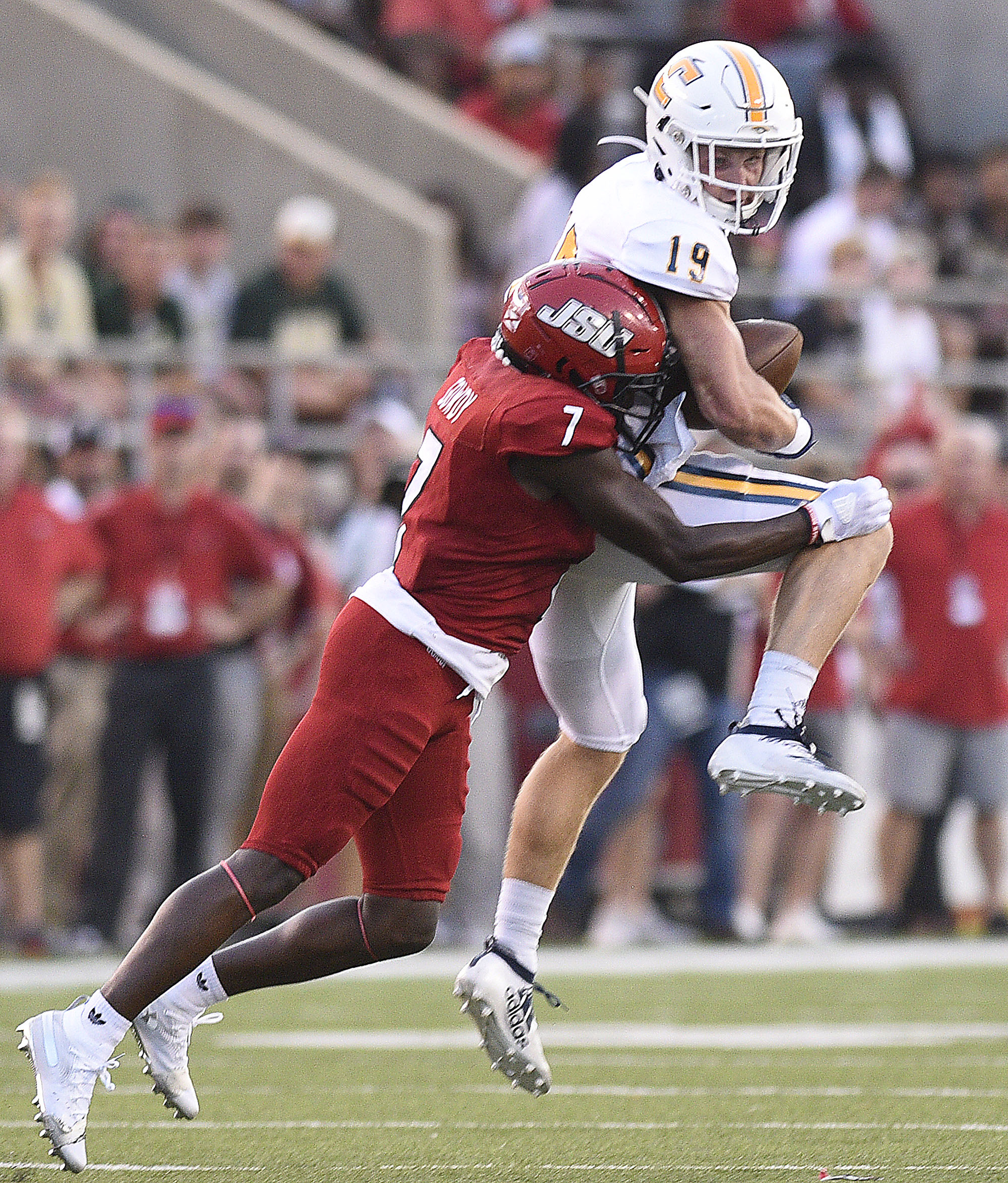 Staff Photo by Robin Rudd/ UTC's Bryce Nunnelly (19) goes up to catch a pass while Jacksonville's Yul Gowdy (7) defends. The University of Tennessee Chattanooga Mocs visited the Jacksonville State Gamecocks in NCAA football action on September 7, 2019.