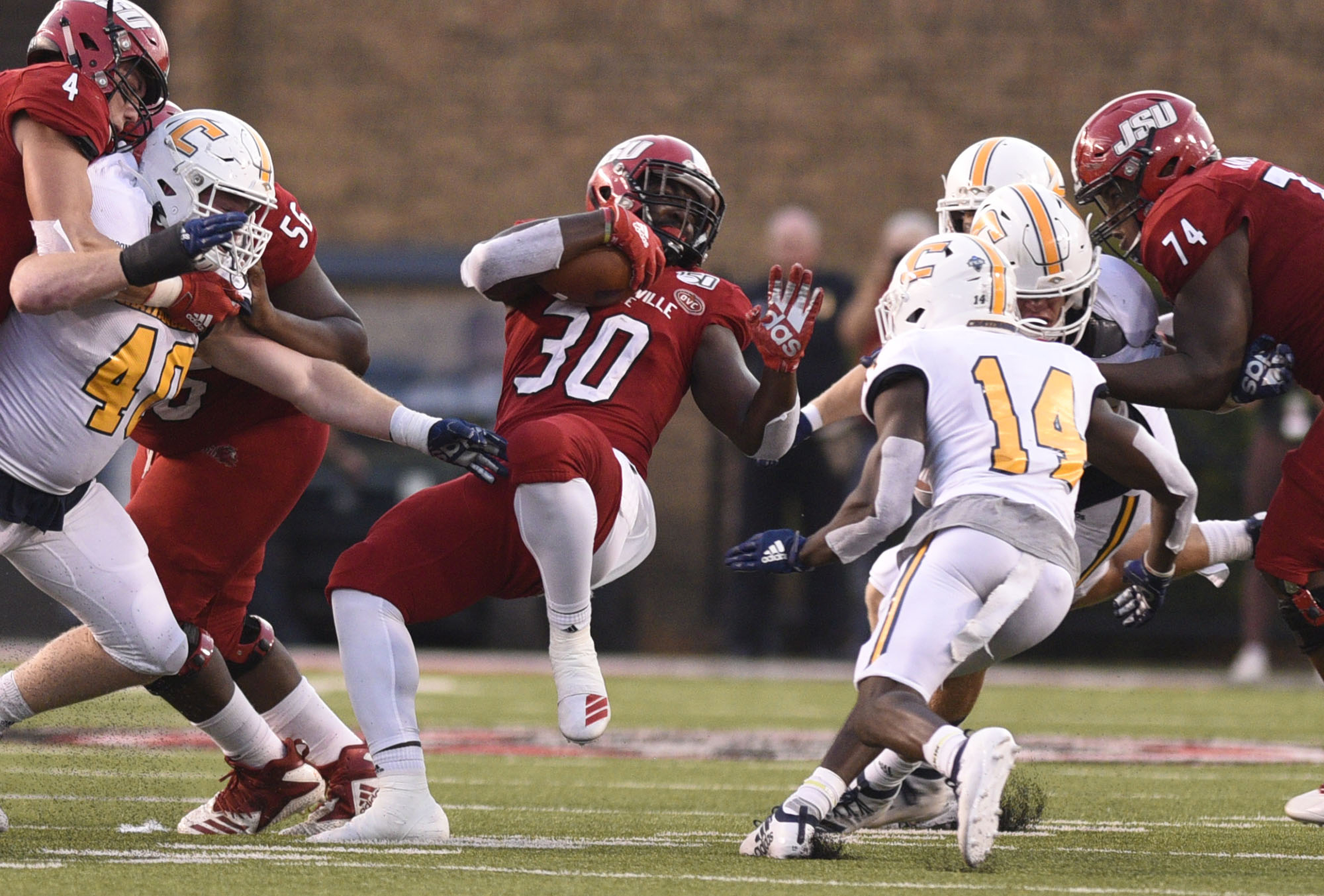 Staff Photo by Robin Rudd/ Jacksonville's Austin Kinsey (30) spins away from UTC tacklers as he runs for a Gamecock touchdown. The University of Tennessee Chattanooga Mocs visited the Jacksonville State Gamecocks in NCAA football action on September 7, 2019.