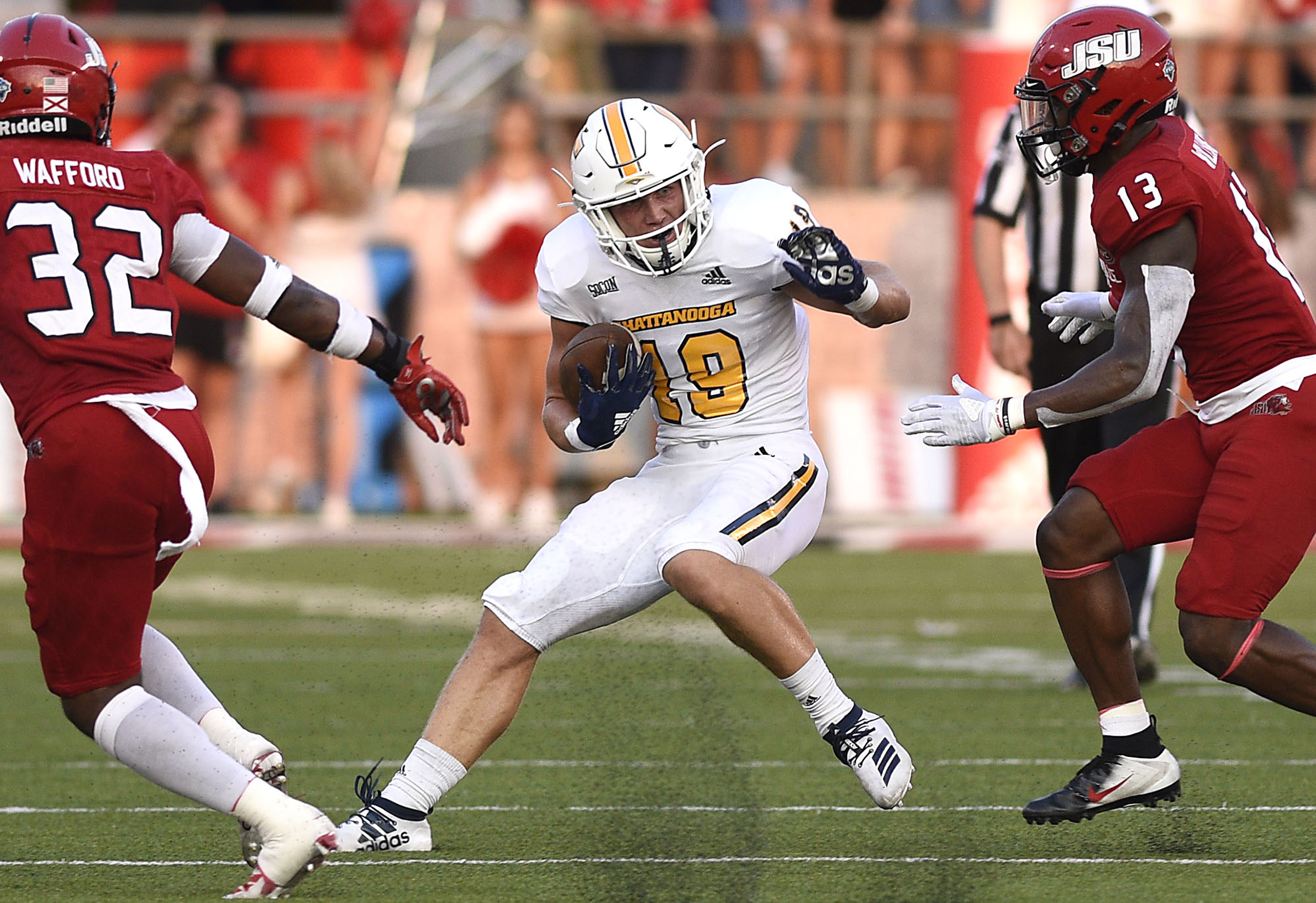 Staff Photo by Robin Rudd/ UTC's Bryce Nunnelly (19) looks for running room after catching a pass. The University of Tennessee Chattanooga Mocs visited the Jacksonville State Gamecocks in NCAA football action on September 7, 2019.