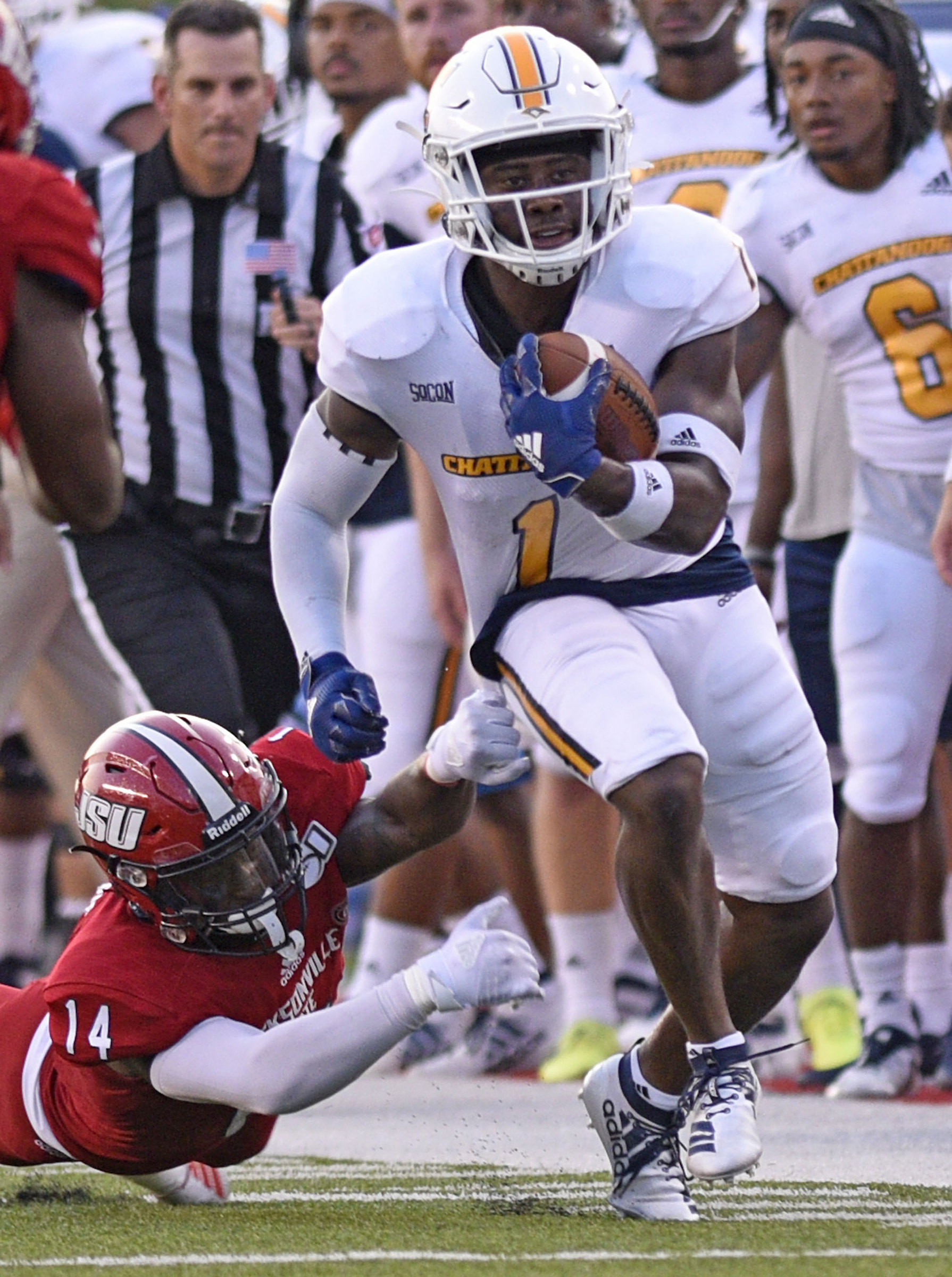 Staff Photo by Robin Rudd/ UTC's Brandon Dowdell (1) returns a punt and breaks the tackle of Jacksonville's Jeremiah Harris (14). The University of Tennessee Chattanooga Mocs visited the Jacksonville State Gamecocks in NCAA football action on September 7, 2019.