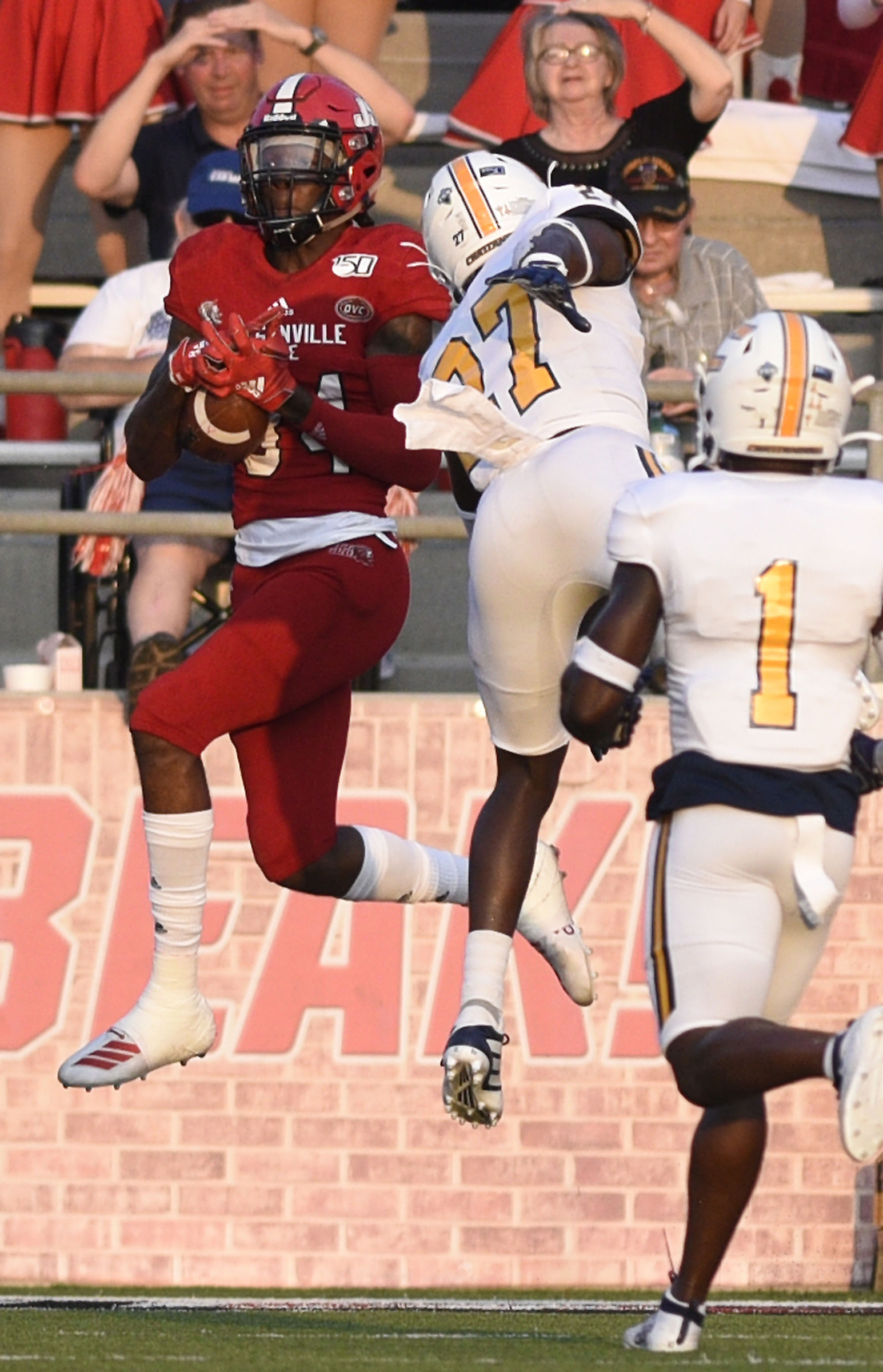 Staff Photo by Robin Rudd/ Jacksonville's Jamari Hester (84) jacks a touchdown pass in front of UTC's Jerrell Lawson (27). The University of Tennessee Chattanooga Mocs visited the Jacksonville State Gamecocks in NCAA football action on September 7, 2019.