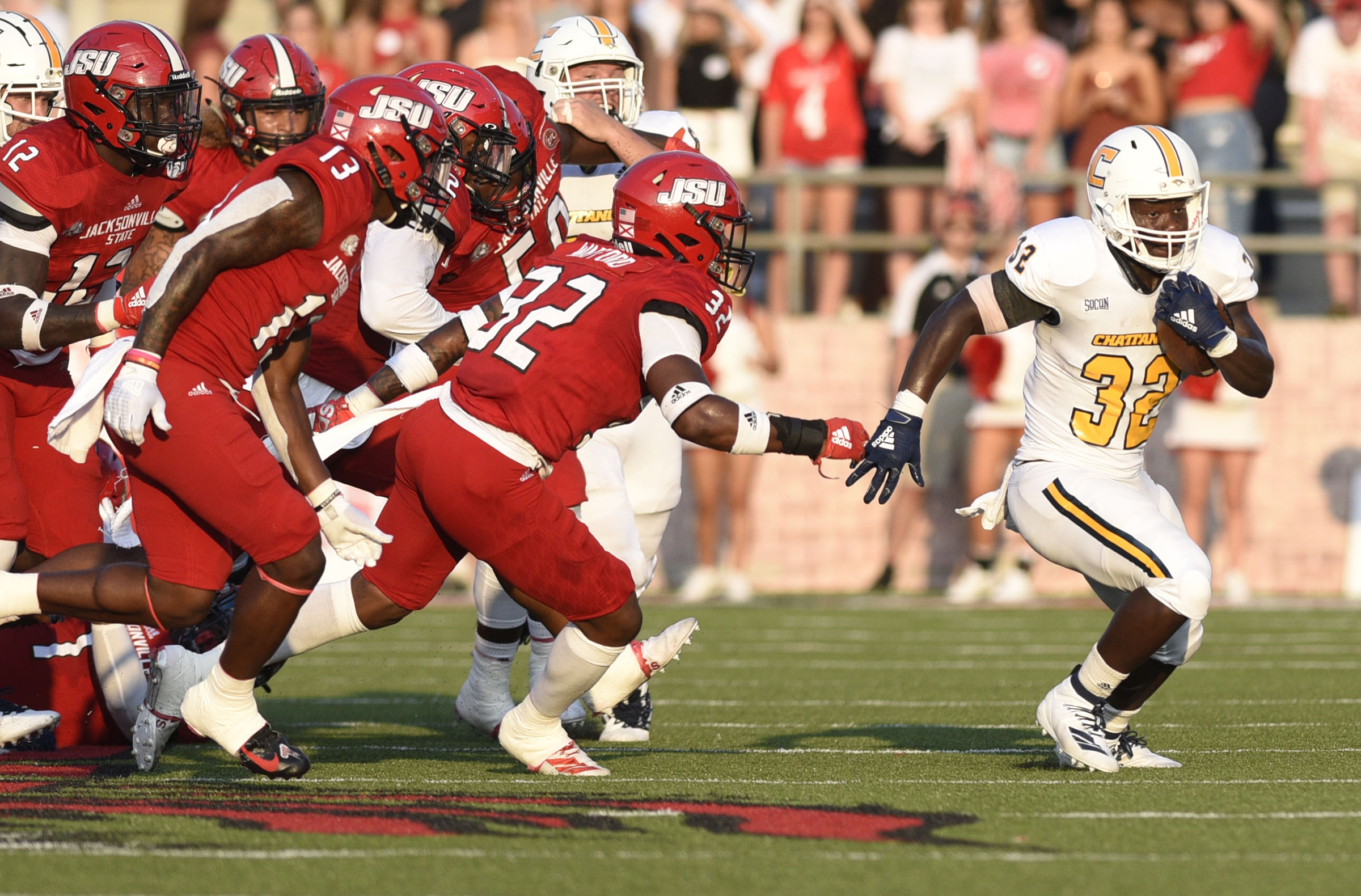 Staff Photo by Robin Rudd / UTC's Ailym Ford flies past a flock of Jacksonville State defenders to turn the corner on a run during Saturday's game.