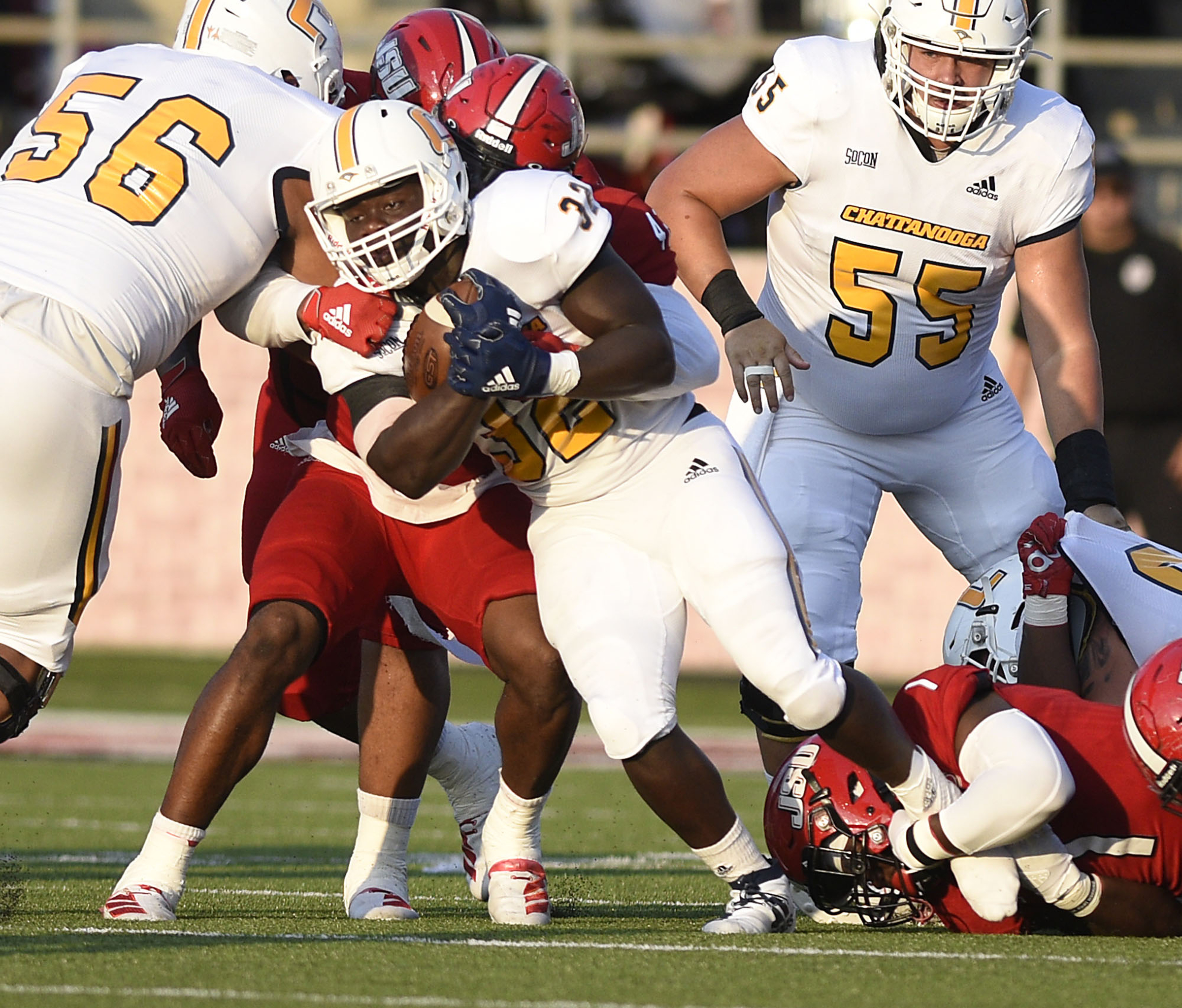 Staff Photo by Robin Rudd/ UTC's Ailym Ford (32) fights for a few yards as he is dragged down by several Gamecock defenders. The University of Tennessee Chattanooga Mocs visited the Jacksonville State Gamecocks in NCAA football action on September 7, 2019.