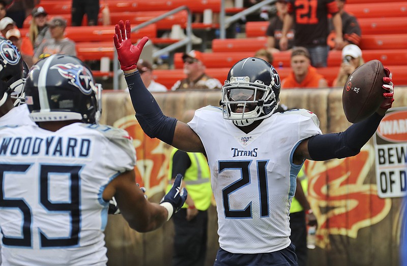 Associated Press photo by Ron Schwane / Tennessee Titans cornerback Malcolm Butler (21) celebrates with linebacker Wesley Woodyard after returning an interception 38 yards for a touchdown during a 45-13 win against the host Cleveland Browns on Sunday in the season opener for both teams.