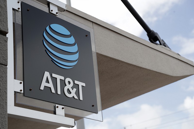 FILE - In this July 18, 2019, file photo, a sign is displayed at an AT&T retail store in Miami. Activist hedge fund manager Elliott Management is making a new $3.2 billion investment in AT&T, saying the company could be valued at more than $60 a share by 2021's end. AT&T stock jumped nearly 6% to $38.31 in Monday, Sept. 9, premarket trading. (AP Photo/Lynne Sladky, File)