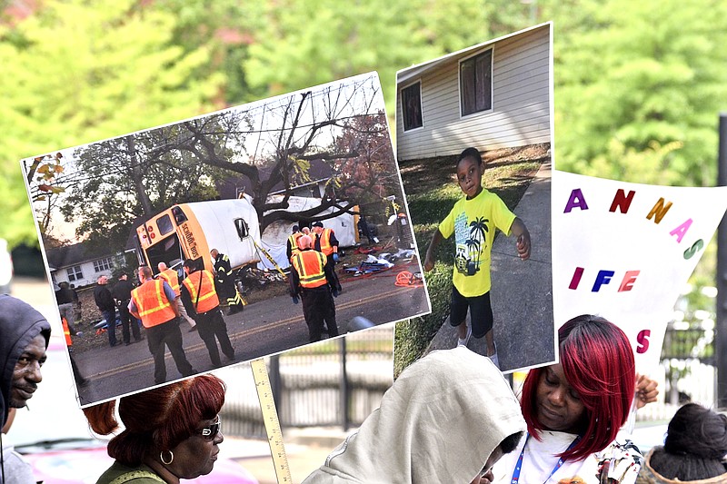 An image of the Woodmore bush crash and one of it's victims adorn signs as people wait to march.  A march was held downtownon May 25, 2017 to remember the victims of the Woodmore Bus Crash and draw attention to Durham Transportation being retained as the contractor for the county's buses.