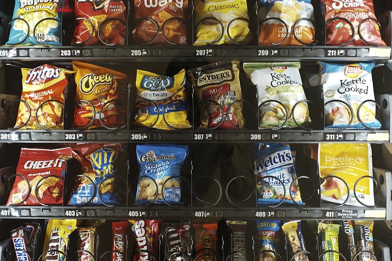This Saturday, Sept. 7, 2019 photo shows items in a vending machine in New York. Americans are addicted to snacks, and food experts are paying closer attention to what that might mean for health and obesity. (AP Photo/Patrick Sison)


