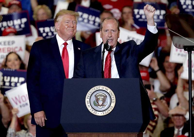 President Donald Trump, left, gives his support to Dan Bishop, right, a Republican running for the special North Carolina 9th District U.S. Congressional race as he speaks at a rally in Fayetteville, N.C., Monday, Sept. 9, 2019. (AP Photo/Chris Seward)