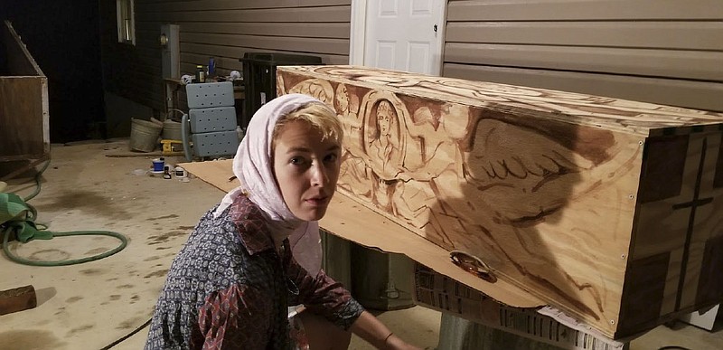 Contributed Photo/  Chattanooga native Abigail Tulis, a sculptor and painter living in New York, paints the box in which her grandmother is to be buried August 6 in Chattanooga.  