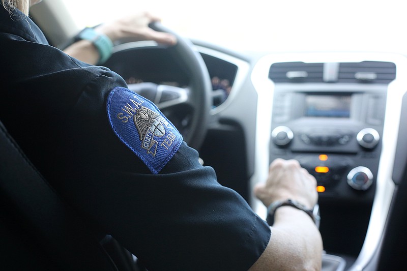 Staff photo by Erin O. Smith / Chattanooga police Lt. Heather Williams's SWAT patch is displayed on her shoulder as she drives from the Chattanooga Police Service Center back to her office at the 11th Street precinct Wednesday, September 11, 2019 in Chattanooga, Tennessee. Williams is the only female SWAT Team member at CPD.