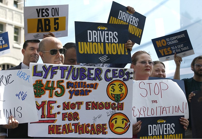 Dozens of supporters of a measure to limit when companies can label workers as independent contractors rally at the Capitol in Sacramento, Calif., Wednesday, Aug. 28, 2019. If approved by the legislature and signed by Gov. Gavin Newsom, AB5, by Assemblywoman Lorena Gonzalez, D-San Diego, would require companies like Uber and Lyft to treat their drivers like employees. (AP Photo/Rich Pedroncelli)



