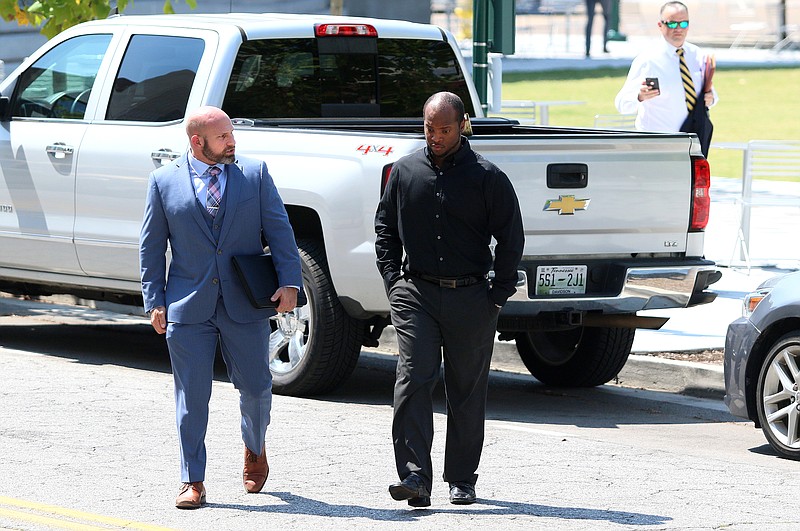 Staff photo by Erin O. Smith / Attorney Sam Byrd and his client former Chattanooga police officer Desmond Logan walk across Georgia Avenue before entering the Joel W. Solomon Federal Building and U.S. Courthouse Thursday, September 12, 2019 in Chattanooga, Tennessee. Logan reached a plea agreement last week, in which he admitted to raping three women in his custody between 2015 and 2018 as well as shooting a Taser at a fourth woman.