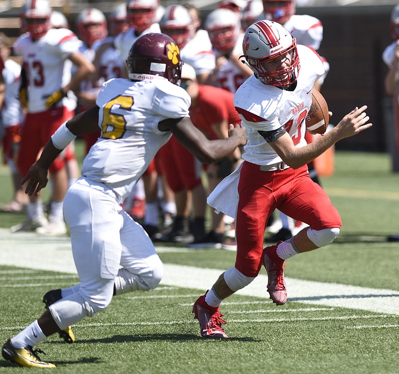 Staff Photo by Robin Rudd / Copper Basin quarterback Bryson Grabowski, right, tries to evade Howard's Javion Robinson during a Best of Preps jamboree matchup Aug. 17 at Finley Stadium.