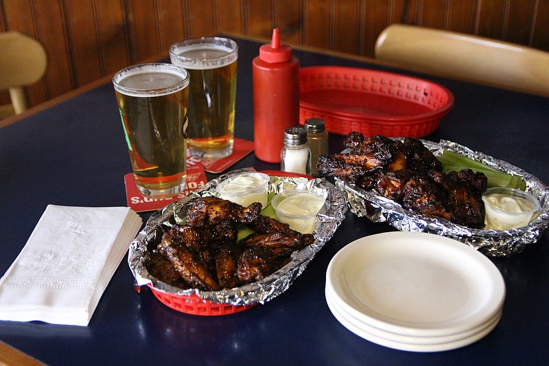 This photo is provided by Visit Buffalo Niagara. Elmo’s is the only Buffalo Wing Trail stop to offer double-dipped wings, which are fried, then sauced, then grilled, then sauced again to create rich flavor and a crunchy texture. (Drew Brown/Visit Buffalo Niagara via AP)