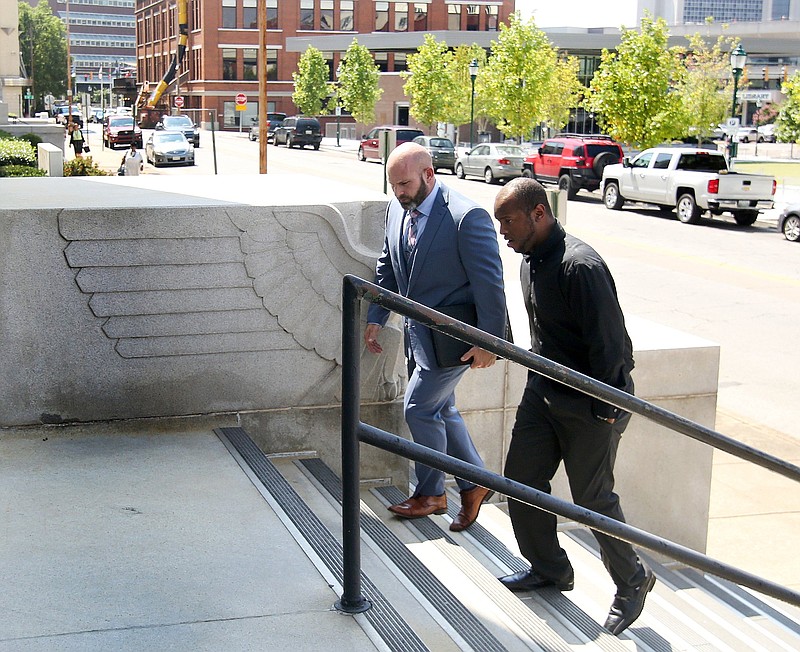 Staff photo by Erin O. Smith / Attorney Sam Byrd walks with his client, former Chattanooga police officer Desmond Logan, into the Joel W. Solomon Federal Building and U.S. Courthouse Thursday, September 12, 2019 in Chattanooga, Tennessee. Logan reached a plea agreement last week, in which he admitted to raping three women in his custody between 2015 and 2018 as well as shooting a Taser at a fourth woman.