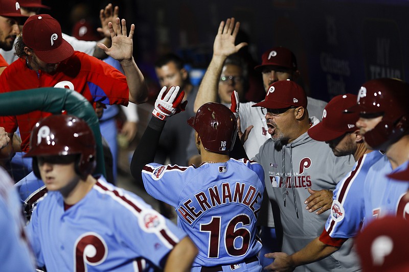 Associated Press photo by Matt Slocum / The Philadelphia Phillies' Cesar Hernandez celebrates in the dugout after hitting a home run off Atlanta Braves starter Julio Teheran during the first inning of Thursday's game in Philadelphia.