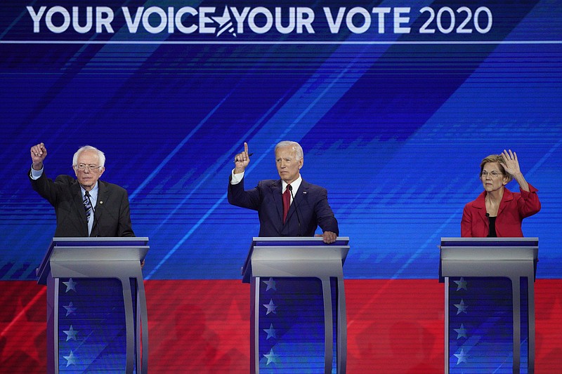 rom left, Democratic presidential candidates Sen. Bernie Sanders, I-Vt., former Vice President Joe Biden and Sen. Elizabeth Warren, D-Mass. raise their hands to answer a question Thursday, Sept. 12, 2019, during a Democratic presidential primary debate hosted by ABC at Texas Southern University in Houston. (AP Photo/David J. Phillip)