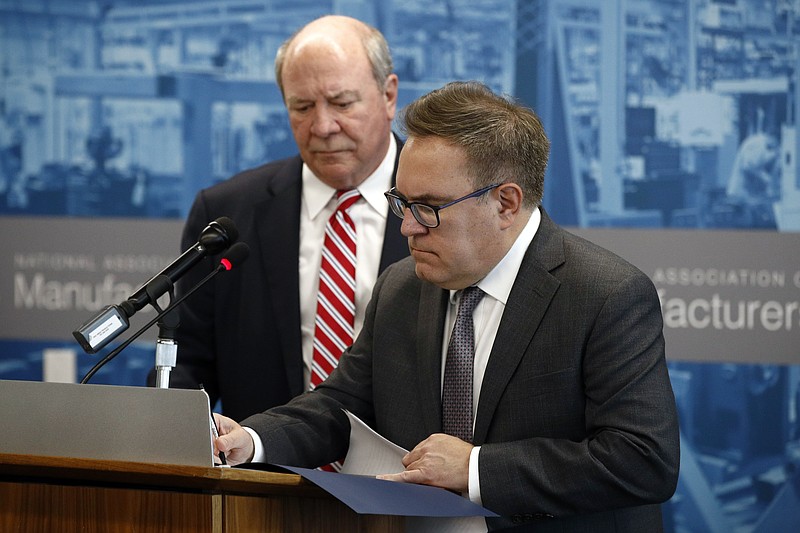 Environmental Protection Agency Administrator Andrew Wheeler, right, signs a document in front of Assistant Secretary of the Army for Civil Works R.D. James to revoke the Waters of the United States rule, an Obama-era regulation that provided federal protection to many U.S. wetlands and streams, Thursday, Sept. 12, 2019, in Washington. (AP Photo/Patrick Semansky)