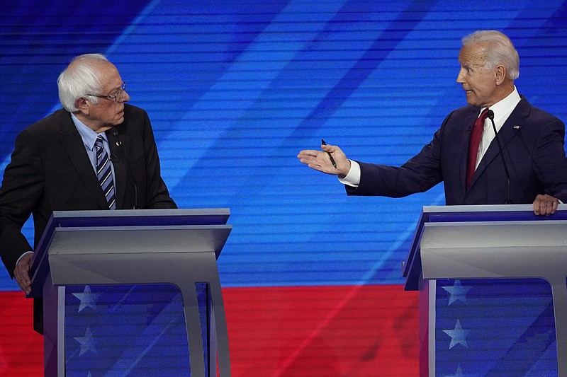 The Associated Press / Sen. Bernie Sanders, I-Vermont, left, listens as former Vice President Joe Biden makes a point during Thursday's Democratic presidential primary debate at Texas Southern University in Houston.