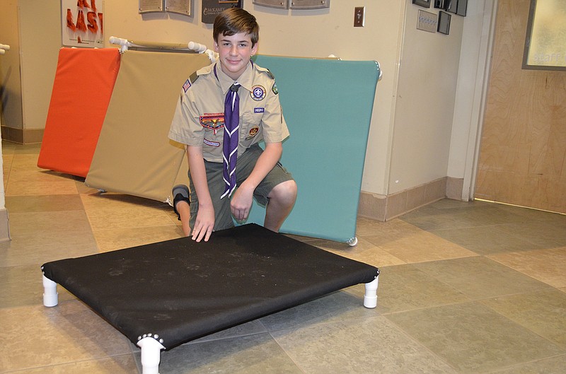 William Hazell displays one of the dog beds he and other volunteers made for dogs at McKamey Animal Center. / Staff photo by Emily Crisman