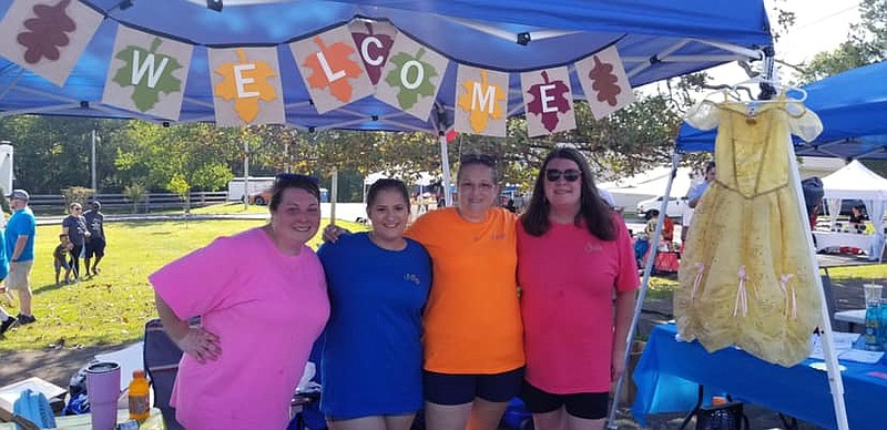 Photo contributed by Angie Wheeland / The Northwest Georgia Youth of Tomorrow team stands at their booth during Labor Day in the Street on Sept. 2 in Fort Oglethorpe. They collected more than 30 costumes for their Community Costume Closet.