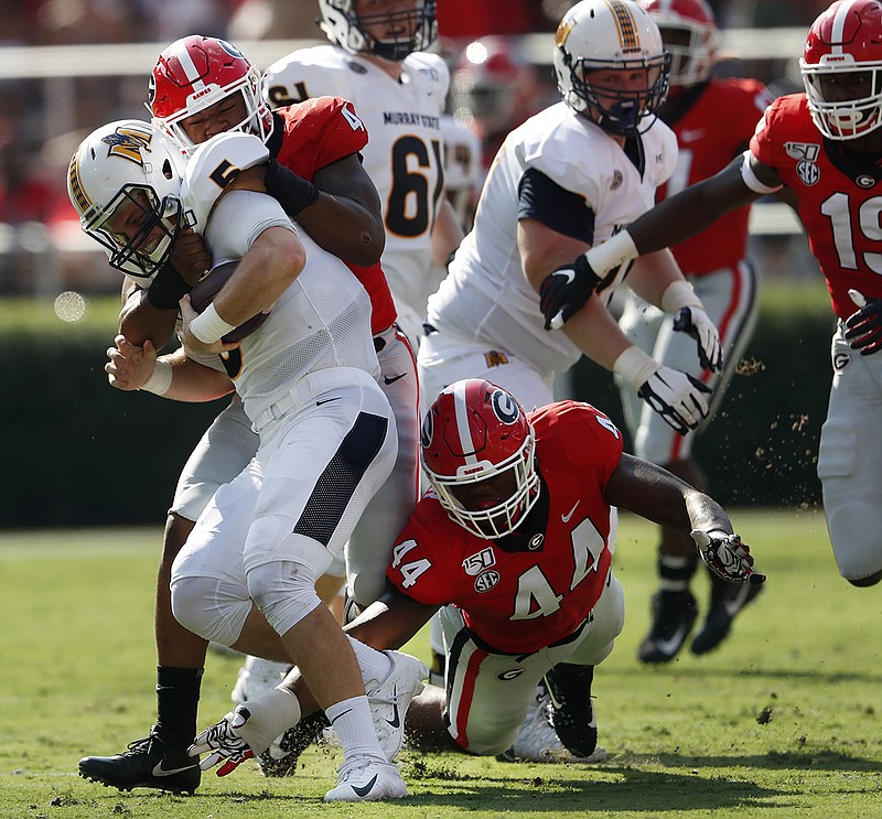 Associated Press photo by John Bazemore / Murray State quarterback Preston Rice (5) is sacked by Georgia's Nolan Smith, rear, and Travon Walker during last Saturday's game in Athens, Ga.