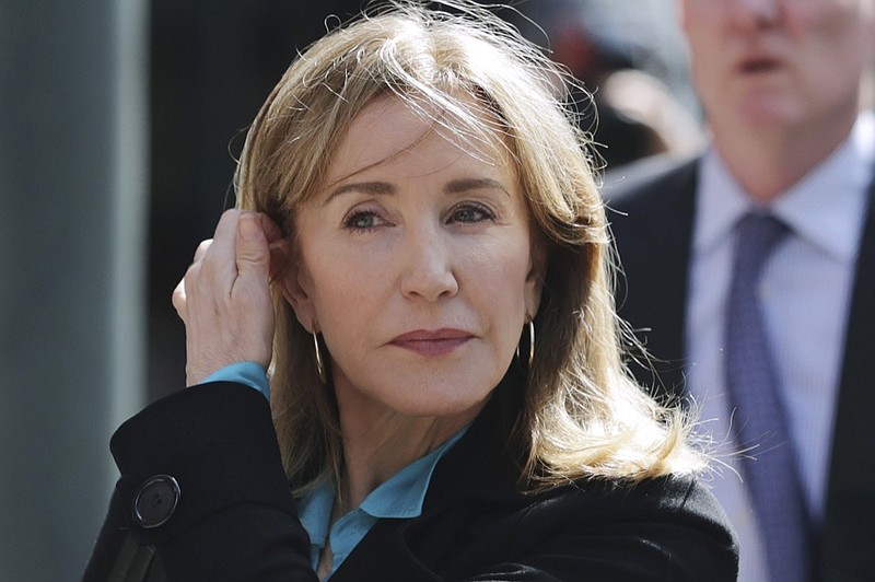 FILE - In this April 3, 2019 file photo, actress Felicity Huffman arrives at federal court in Boston to face charges in a nationwide college admissions bribery scandal. Huffman, who pleaded guilty to a single count of conspiracy and fraud in May, is returning for sentencing in federal on Friday, Sept. 13, 2019 court in Boston. (AP Photo/Charles Krupa, File)


