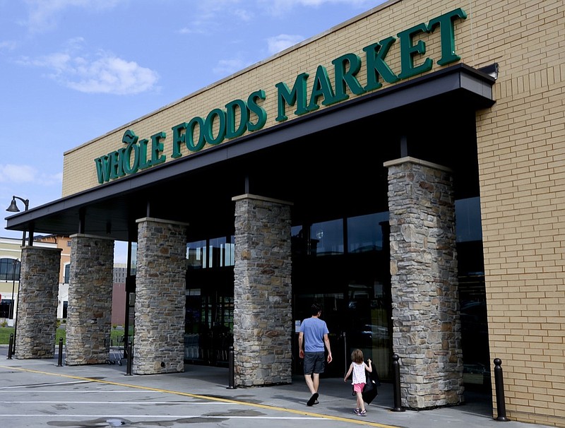 In this Aug. 8, 2018, photo shoppers enter a Whole Foods Market in Upper Saint Clair, Pa. Whole Foods, the grocery chain owned by Amazon, is cutting health care benefits for its part-time workers, a move that could leave about 1,900 of its employees without medical coverage. Starting next year, Whole Foods employees have to work at least 30 hours a week to qualify for its health care benefits, up from the 20 hours a week it currently requires. (AP Photo/Gene J. Puskar, File)


