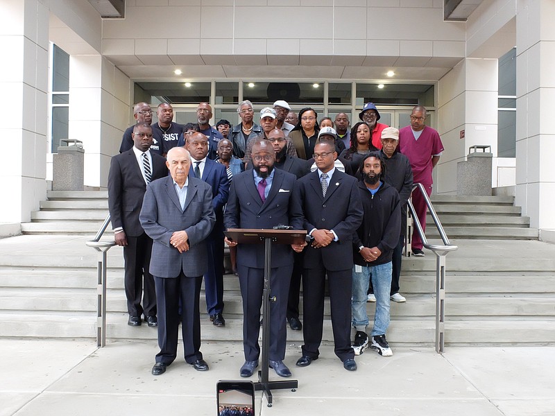 Staff photo by Tim Barber/ Rev. Tim Careathers stands with nearly thirty supporters and reads a prepared statement to the media on the steps of the Hamilton County Chattanooga Courts Building at noon Monday. Area pastors and ministers called for District Attorney Neal Pinkston to fire Hamilton County Sheriff, and a deputy, for refusal to protect citizens and failure to control officers.