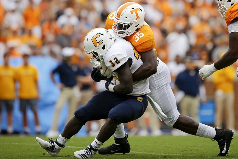 Staff photo by C.B. Schmelter / Tennessee linebacker Daniel Bituli tackles UTC running back Ailym Ford during Saturday's game at Neyland Stadium.
