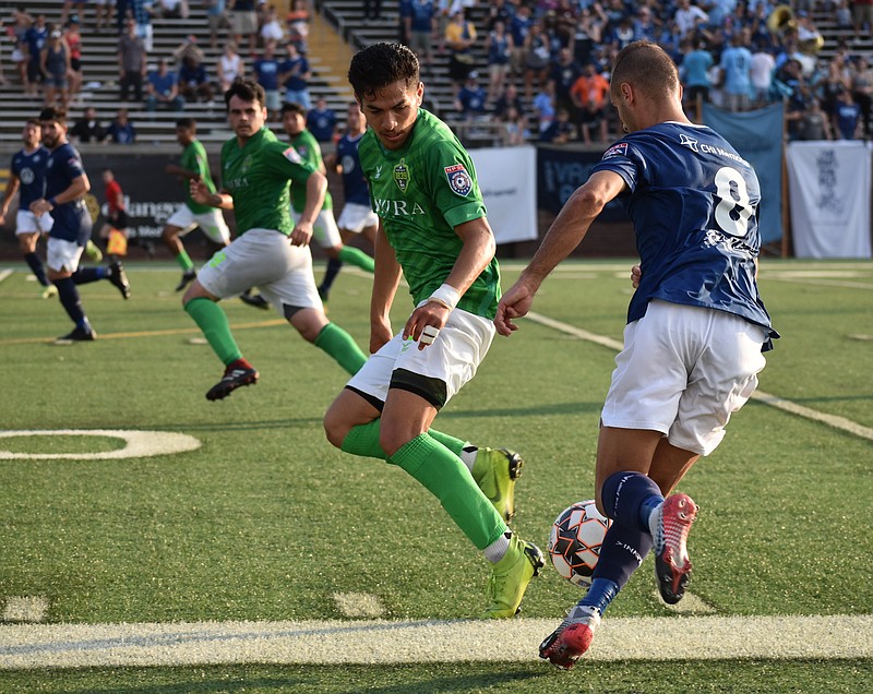 Staff photo by Patrick MacCoon / Chattanooga FC's Joao Costa, right, makes a move on a Napa Valley 1839 FC defender during Saturday night's match at Finley Stadium. CFC won 3-0.
